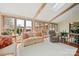 Bright sunroom with large windows, skylights, neutral furniture, and views of the landscaped backyard at 101 Woodvale Cir, Lincolnton, NC 28092