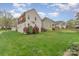 A spacious back yard with green grass, plants, and a clear view of the house at 10802 Tradition View Dr, Charlotte, NC 28269