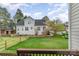 Spacious backyard with lush green grass, a wooden fence, and mature trees at 10802 Tradition View Dr, Charlotte, NC 28269