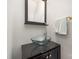 Stylish powder room featuring a modern glass bowl sink, dark vanity, and sleek mirror at 10802 Tradition View Dr, Charlotte, NC 28269