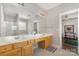 Bright bathroom with a large mirror over double sinks and a door into the shower at 10802 Tradition View Dr, Charlotte, NC 28269