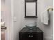 Chic powder room with a modern glass bowl sink, a dark vanity, and elegant fixtures at 10802 Tradition View Dr, Charlotte, NC 28269