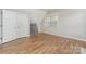 Bedroom featuring hardwood floors and a window, alongside a large closet at 10802 Tradition View Dr, Charlotte, NC 28269
