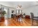 Bright dining area featuring hardwood floors, a fireplace, and a ceiling fan for comfortable entertaining at 10802 Tradition View Dr, Charlotte, NC 28269