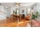 Cozy dining room area with hardwood floors, a fireplace, and ample natural light from the windows at 10802 Tradition View Dr, Charlotte, NC 28269