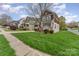 View of the home, showcasing the landscaping and architectural style at 10802 Tradition View Dr, Charlotte, NC 28269