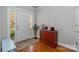 A well-lit foyer with a dresser and view of the front door at 10802 Tradition View Dr, Charlotte, NC 28269