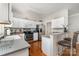 Efficient kitchen featuring white cabinetry, stainless steel appliances, and bar seating for casual dining at 10802 Tradition View Dr, Charlotte, NC 28269