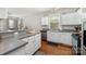 Well-lit kitchen boasting white cabinets, stainless steel appliances, and a functional layout at 10802 Tradition View Dr, Charlotte, NC 28269