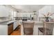 Beautiful kitchen featuring white cabinets, stainless steel appliances, and bar seating for casual dining at 10802 Tradition View Dr, Charlotte, NC 28269