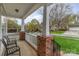 Inviting porch with brick pillars and seating area, perfect for enjoying the outdoors at 10802 Tradition View Dr, Charlotte, NC 28269