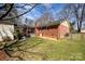 Large grassy backyard with trees, a shed, and a brick home at 11018 Despa Dr, Mint Hill, NC 28227