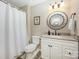 Bathroom with a white vanity, framed round mirror, and a shower with a white curtain at 11018 Despa Dr, Mint Hill, NC 28227