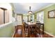 Bright dining room with hardwood floors, a charming light fixture, and a view to the side yard at 11018 Despa Dr, Mint Hill, NC 28227