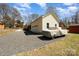 Exterior view of the house with an attached garage, covered truck, and gravel driveway at 11018 Despa Dr, Mint Hill, NC 28227