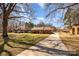 Traditional brick home with long driveway, showcasing a well-maintained lawn and established landscaping in a quiet setting at 11018 Despa Dr, Mint Hill, NC 28227