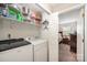 Practical laundry room including washer, dryer, storage shelves, and access to the bedroom at 11018 Despa Dr, Mint Hill, NC 28227