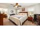 Spacious main bedroom with a ceiling fan, natural light, and ensuite bathroom access at 11018 Despa Dr, Mint Hill, NC 28227