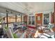 Inviting screened-in porch featuring wicker seating and a view of the backyard at 11018 Despa Dr, Mint Hill, NC 28227