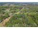 Aerial view highlighting the property's privacy, surrounded by lush trees, offering a serene and secluded living experience at 123 Lucy Ln, Statesville, NC 28625