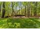 Picturesque backyard with manicured lawn and a charming firepit area at 123 Lucy Ln, Statesville, NC 28625