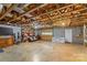 Unfinished basement with exposed beams and shelving, presenting ample storage opportunities at 123 Lucy Ln, Statesville, NC 28625