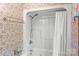 Clean bathroom with white shower and patterned wallpaper for vintage style at 123 Lucy Ln, Statesville, NC 28625