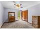 Comfortable bedroom featuring a ceiling fan, closet, dresser, and an outside view at 123 Lucy Ln, Statesville, NC 28625