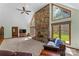 Bright and airy living room with a stone fireplace and large windows overlooking the yard at 123 Lucy Ln, Statesville, NC 28625