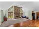 Open living room features a stone fireplace, large windows, and vaulted ceilings at 123 Lucy Ln, Statesville, NC 28625