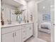 Modern bathroom featuring double sinks, white cabinets, and gray tile flooring at 1279 31St St, Conover, NC 28613