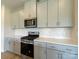 Well-lit kitchen features stainless steel appliances, gray cabinets, and white tile backsplash at 1279 31St St, Conover, NC 28613