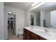 Bathroom featuring double sinks, cherry cabinetry, and a large mirror and walk-in closet at 12915 Settlers Trail Ct, Charlotte, NC 28278