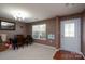 Dining room features a large window, chandelier, and a spacious table to gather for meals at 12915 Settlers Trail Ct, Charlotte, NC 28278