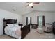 Serene main bedroom with vaulted ceilings, a large bed, and cozy seating area at 12915 Settlers Trail Ct, Charlotte, NC 28278
