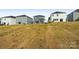 View of the home's backyard with a view of the other gray and white homes on the block at 1305 31St Ne St, Conover, NC 28613
