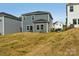 The rear of the home, featuring a sunroom attachment, and a modest amount of grass for outdoor enjoyment at 1305 31St Ne St, Conover, NC 28613