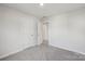 Inviting bedroom showcasing neutral colors, plush carpeting, and access to additional rooms at 1305 31St Ne St, Conover, NC 28613