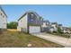 Features a two-car garage, landscaped front yard, and views of neighboring properties under a clear blue sky at 1305 31St Ne St, Conover, NC 28613