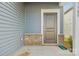 Home's front entrance with a dark brown door, brick accents, and gray siding at 1305 31St Ne St, Conover, NC 28613