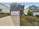 Two-story home with blue siding, brick accents, white garage door, and well-maintained landscaping at 1305 31St Ne St, Conover, NC 28613