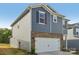 Two-story home with gray siding, brick accents, and a white two-car garage door at 1305 31St Ne St, Conover, NC 28613