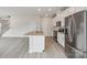 Modern kitchen with stainless steel appliances, granite countertops, and an island with a sink, perfect for entertaining at 1305 31St Ne St, Conover, NC 28613
