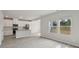 Bright, open living area with modern gray wood-look floors, a view of the kitchen, and natural light from large windows at 1305 31St Ne St, Conover, NC 28613
