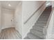 Bright entryway showcases a carpeted staircase leading to the upper level with white risers and a light wood handrail at 1305 31St Ne St, Conover, NC 28613
