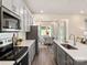Modern kitchen with sleek gray cabinets, white countertops, and stainless steel appliances open to dining area at 1329 31St Ne St, Conover, NC 28613