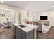 Open-concept living space with kitchen island, dining area, and cozy living room with plenty of natural light at 1329 31St Ne St, Conover, NC 28613