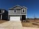 Charming two-story home with gray siding, stone accents, and a pristine white garage door at 1361 31St Ne St, Conover, NC 28613