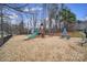 Community playground featuring a slide, climbing structure, swings, and picnic area for outdoor fun at 13914 Cypress Woods Dr, Huntersville, NC 28078