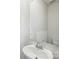 Modern half-bath featuring a sleek pedestal sink, a mirror, and a toilet, designed with minimalist elegance at 1466 31St Ne St, Conover, NC 28613